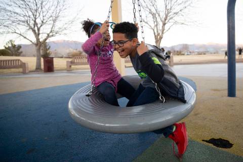 Kristina, left, 6, and her brother Owen, 8, play as their foster parent and North Las Vegas pol ...