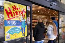 FILE - A hiring sign is displayed at a grocery store in Arlington Heights, Ill., Friday, Jan. 1 ...