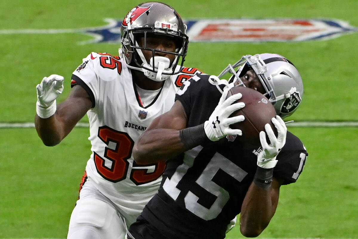 Las Vegas Raiders wide receiver Nelson Agholor (15) catches a pass over Tampa Bay Buccaneers co ...