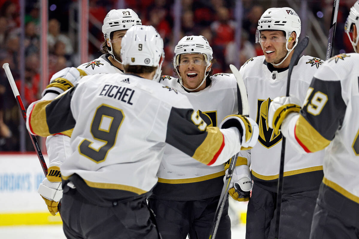 Vegas Golden Knights' Jonathan Marchessault, center, celebrates his goal with teammates Shea Th ...