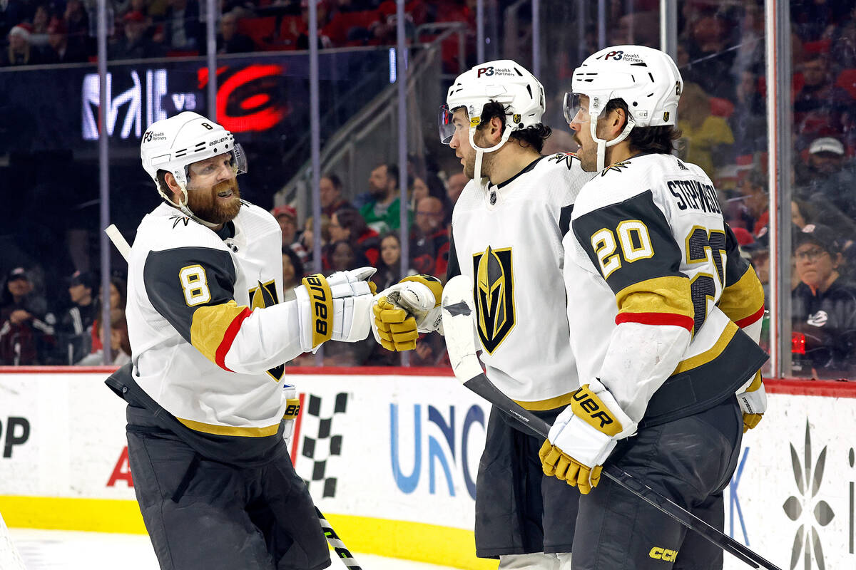 Vegas Golden Knights' Paul Cotter, center, celebrates his goal with Phil Kessel (8) and Chandle ...