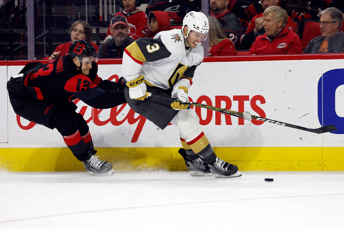 Vegas Golden Knights' Brayden McNabb (3) protects the puck from Carolina Hurricanes' Jesse Pulj ...