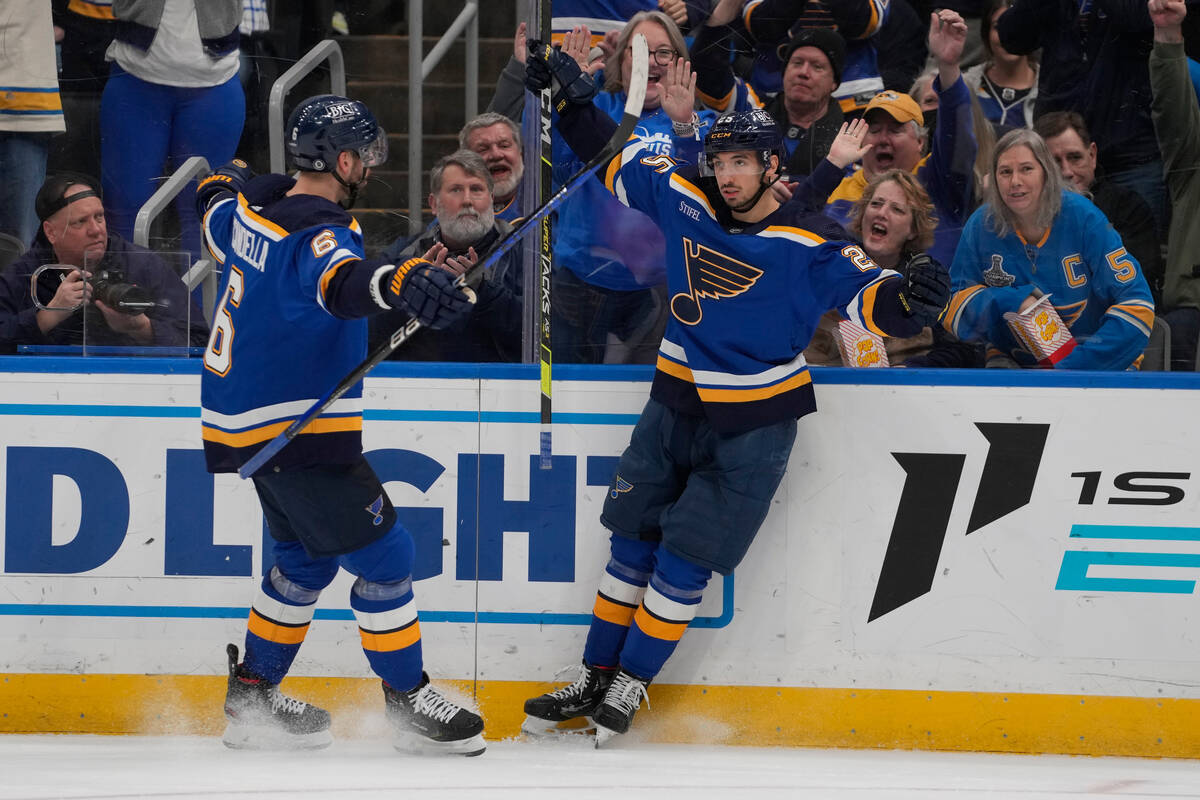 St. Louis Blues' Jordan Kyrou, right, is congratulated by Marco Scandella after scoring during ...