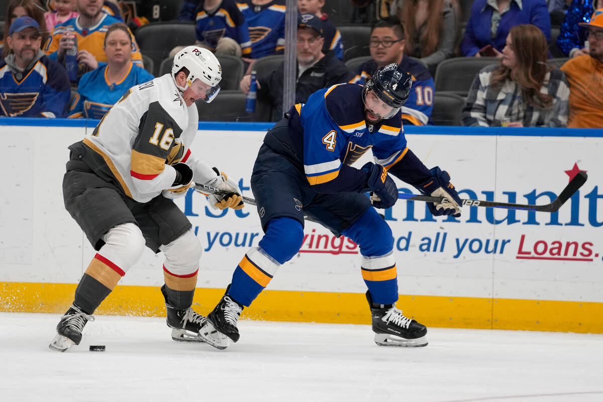 Vegas Golden Knights' Pavel Dorofeyev (16) and St. Louis Blues' Nick Leddy (4) battle for a loo ...