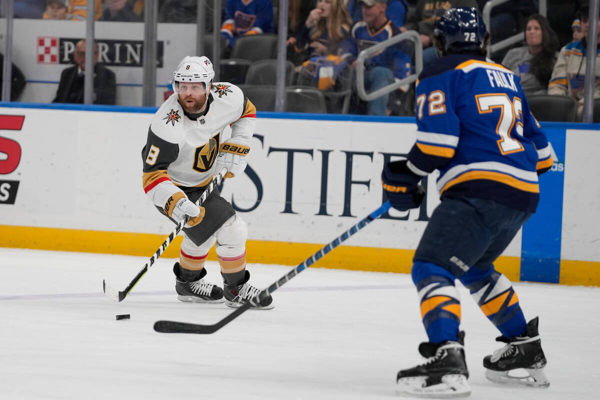 St. Louis Blues' Justin Faulk (72) checks Vegas Golden Knights