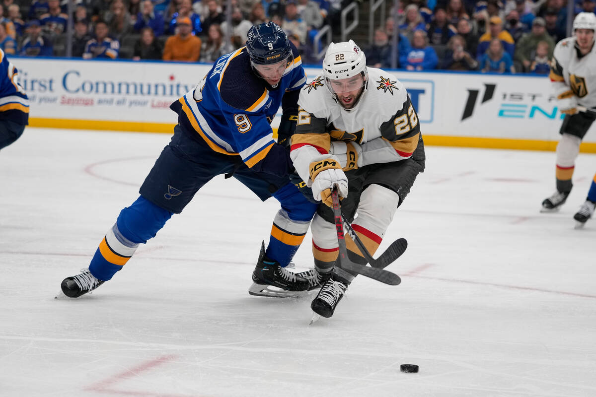St. Louis Blues' Tyler Pitlick (9) and Vegas Golden Knights' Michael Amadio (22) battle for a l ...