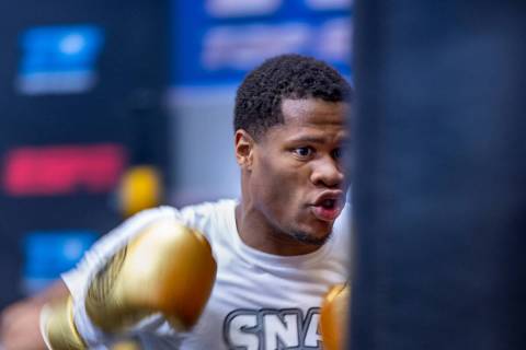 WBC lightweight boxer Devin Haney throws a punch on a heavy bag during a workout session at the ...