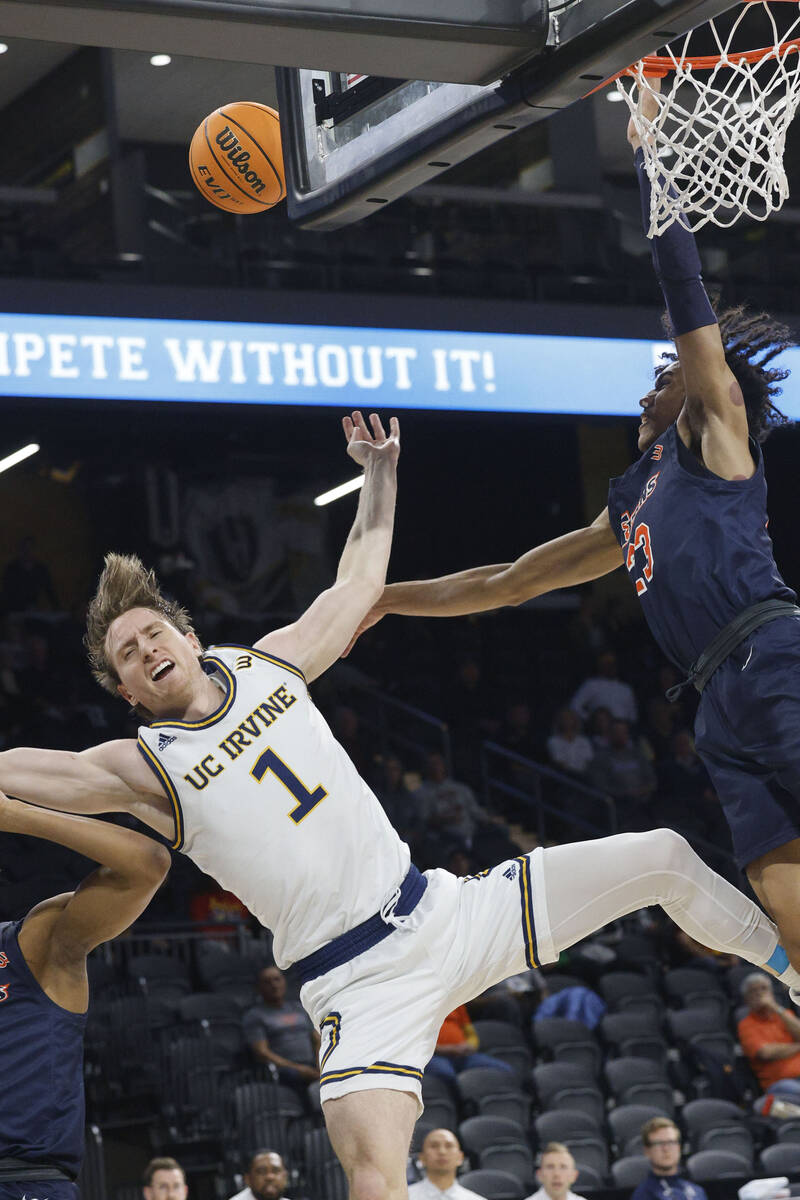 UC Irvine Anteaters guard Dawson Baker (1) loses his balance after attempting a jump shot as Ca ...