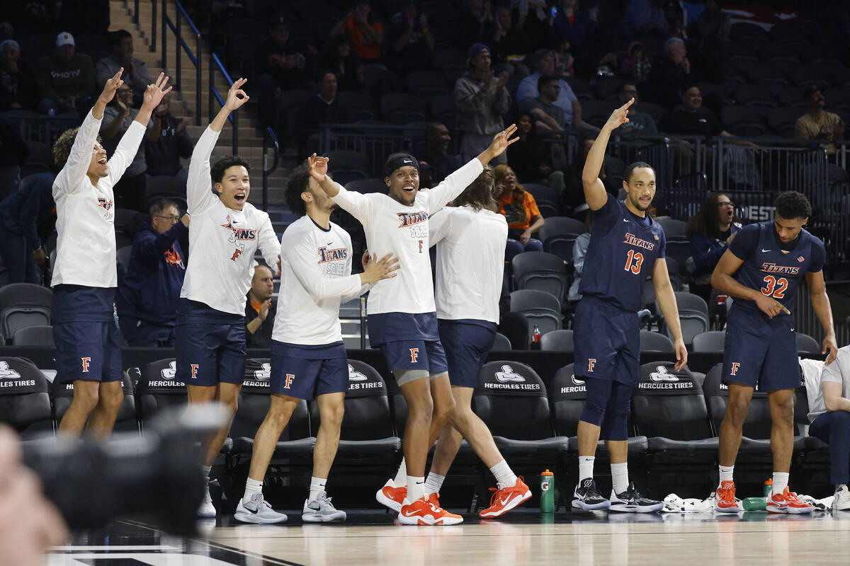 Cal State Fullerton Titans players cheer during the first half of an NCAA college basketball ga ...