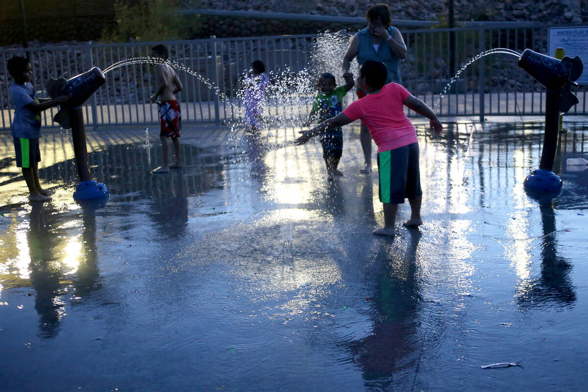 Children play in the water park at Lorenzi Park on Sunday, June 18, 2017 in Las Vegas. At 8p.m. ...