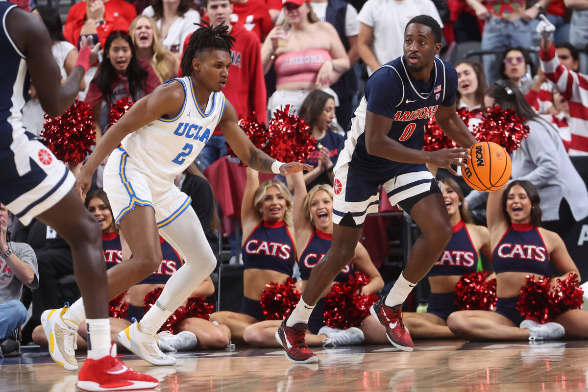 Arizona guard Courtney Ramey (0) is defended by UCLA guard Dylan Andrews (2) during the second ...
