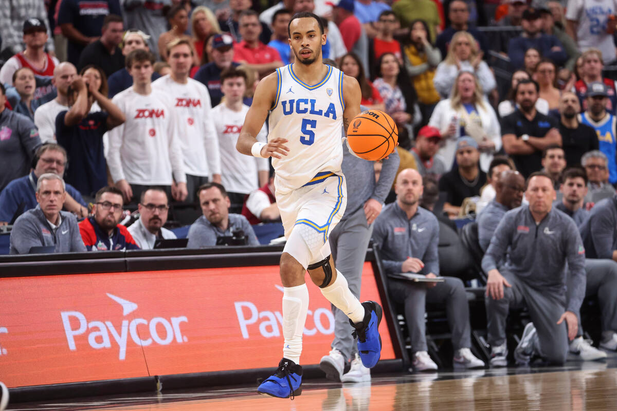 UCLA guard Amari Bailey (5) brings the ball up against Arizona during the second half of an NCA ...