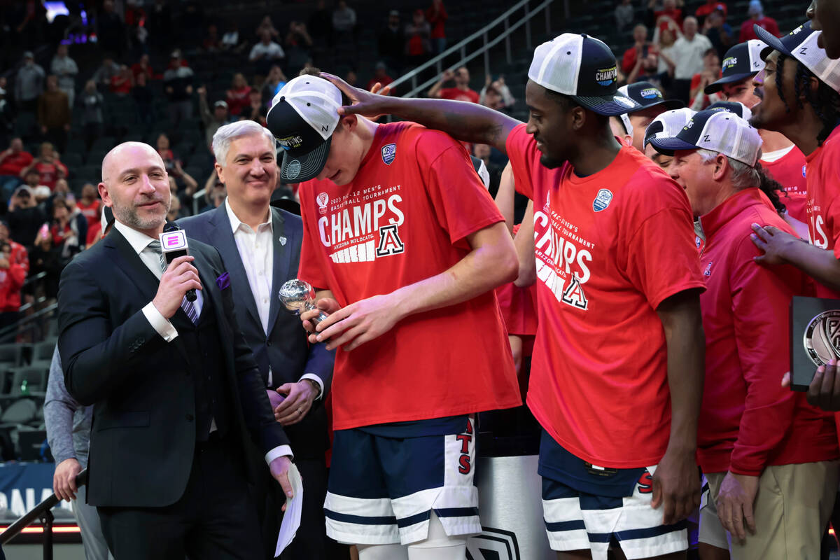 Arizona forward Azuolas Tubelis, center, is awarded the tournament most outstanding player trop ...