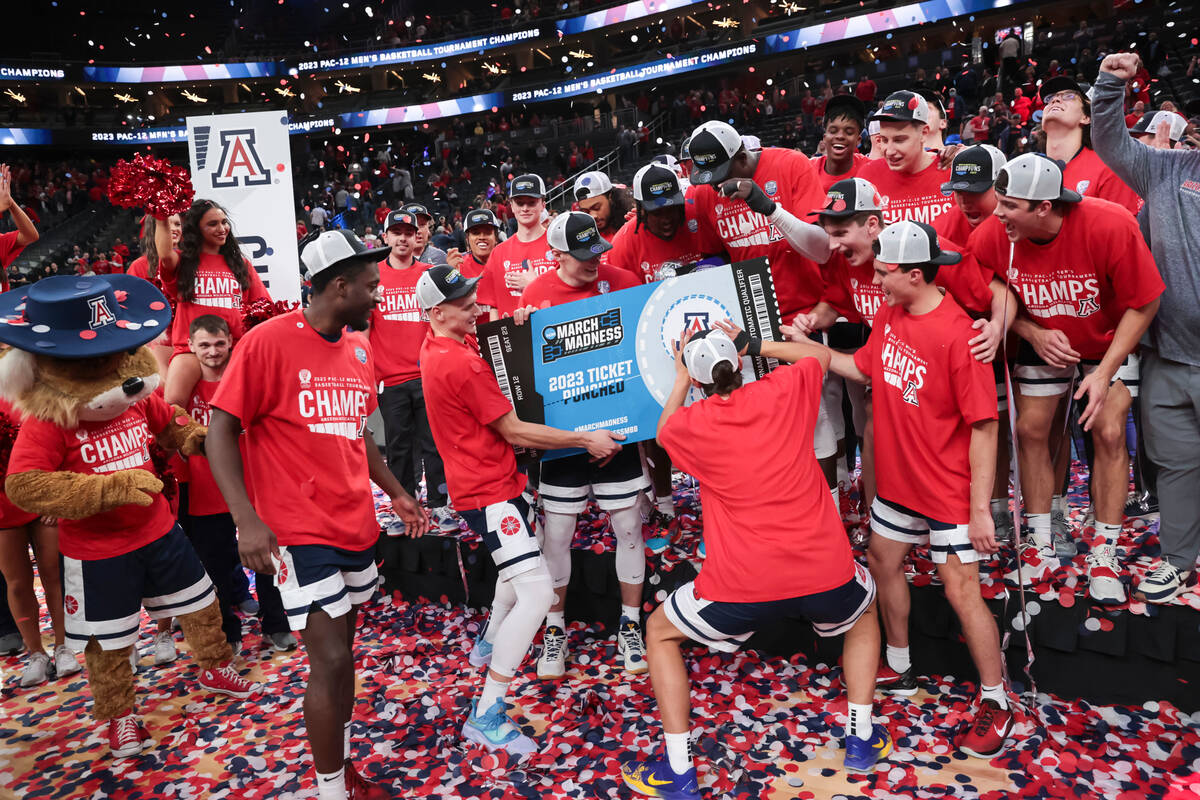 Arizona players celebrate after defeating UCLA in an NCAA college basketball game for the champ ...
