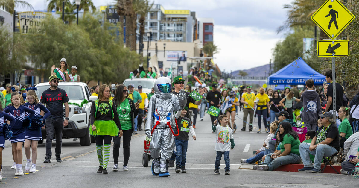 A spaceman is joined by other participants as they march along the parade route down Water Stre ...