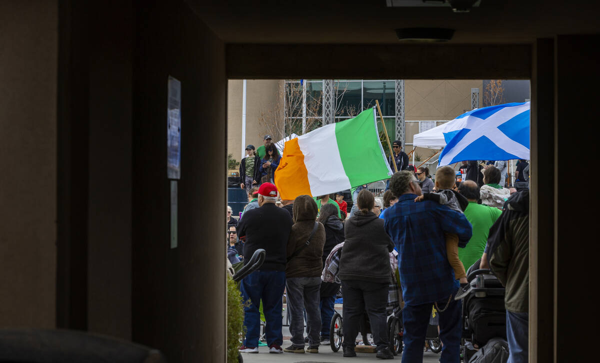Attendees fill the sidewalks for the parade down Water Street during the St. Patrick’s D ...