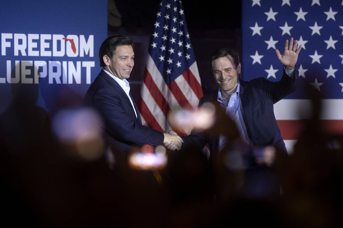 Florida Gov. Ron DeSantis shakes former Nevada Attorney General Adam Laxalt’s hand durin ...