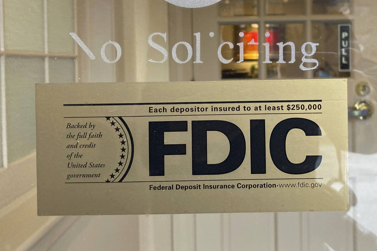 An FDIC sign is posted on a window at a Silicon Valley Bank branch in Wellesley, Mass., on Satu ...