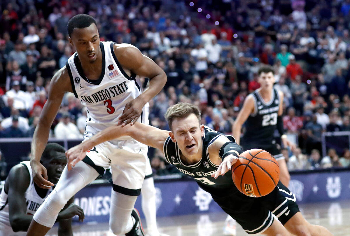 Utah State guard Steven Ashworth (3) dives for the ball in front of San Diego State guard Micah ...