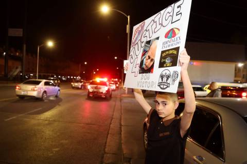 Romeo Vasquez holds up a sign calling for justice during a buyout event in support of the taco ...