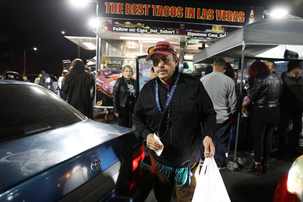 Victor Medina delivers food to customers during a buyout event in support of the taco street ve ...