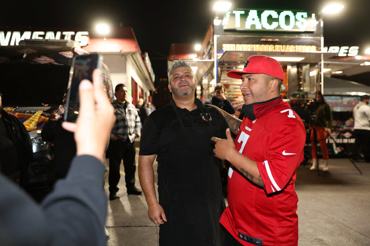 Street vendor activist Edin Alex Enamorado, right, talks to Lazaro Correa, an employee of Casa ...