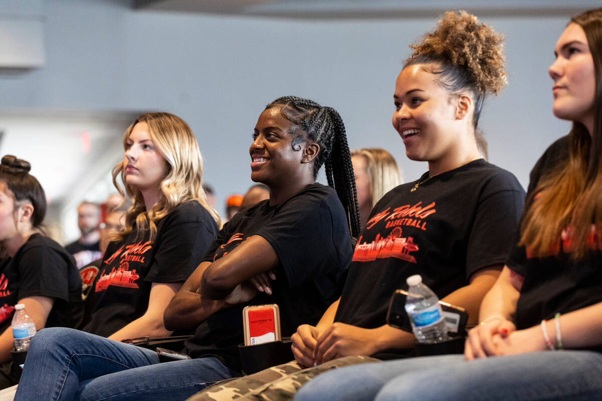 UNLV Lady Rebels players, from left, Kenadee Winfrey, Desi-Rae Young and Nneka Obiazor watch t ...