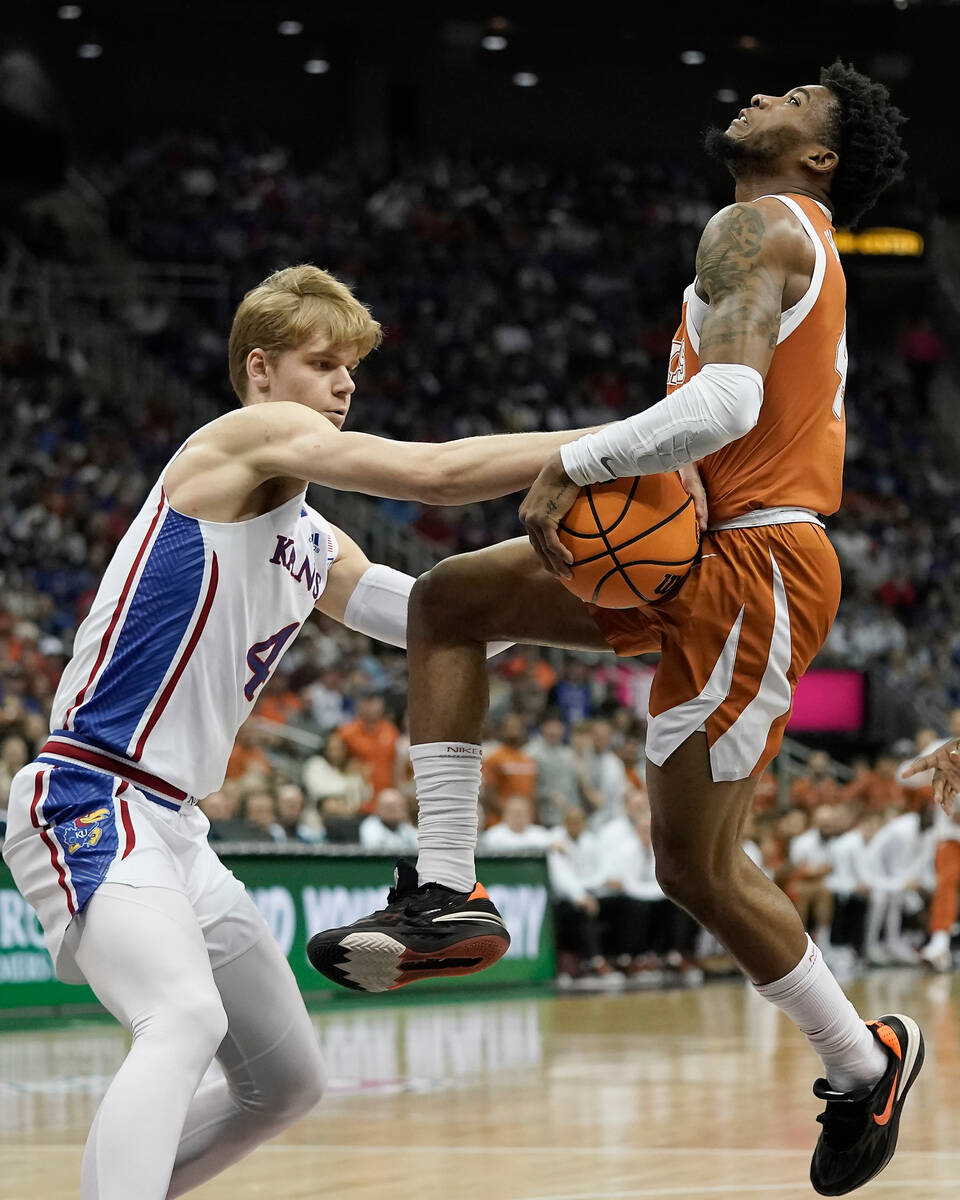 Kansas guard Gradey Dick, left, tries to steal the ball from Texas guard Tyrese Hunter during t ...