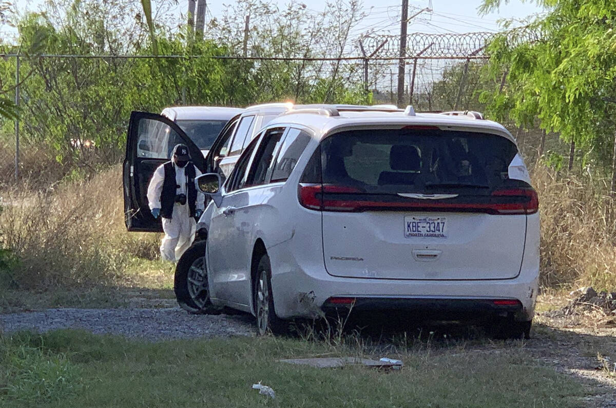 A Mexican police investigator inspects the minivan were four Americans where shot and taken fro ...