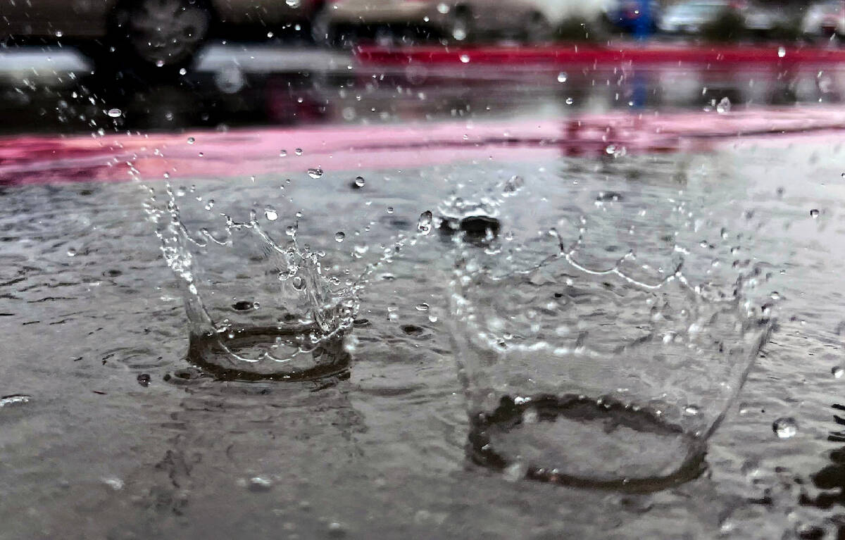 Raindrops hit a small puddle downtown on Tuesday, March 14, 2023, in Las Vegas. (L.E. Baskow/La ...