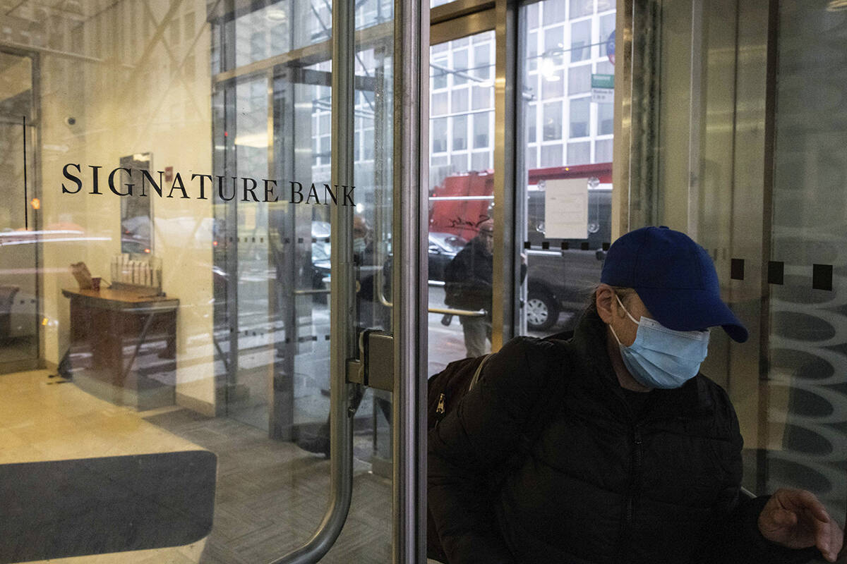 A person leaves one of the Signature Bank branches in New York, Monday, March. 13, 2023. Presid ...