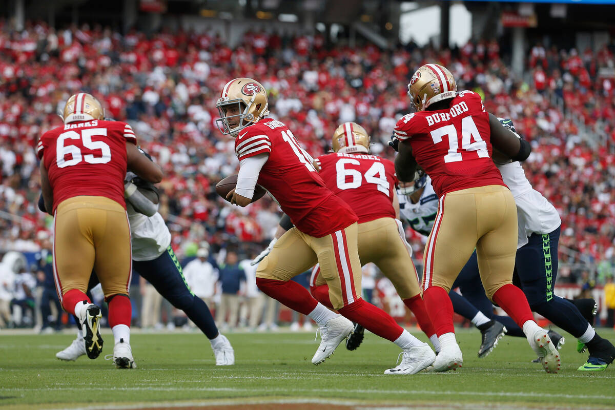 San Francisco 49ers quarterback Jimmy Garoppolo (10) looks to hand the ball off during an NFL f ...