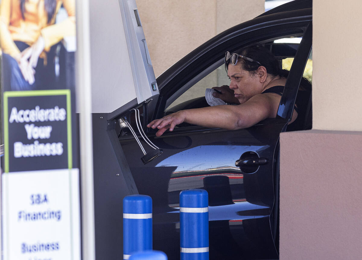 A customer uses an ATM machine at the Nevada State Bank drive-thru, on Monday, March 13, 2023, ...