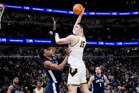 Purdue center Zach Edey, right, shoots over Penn State forward Kebba Njie during the second hal ...