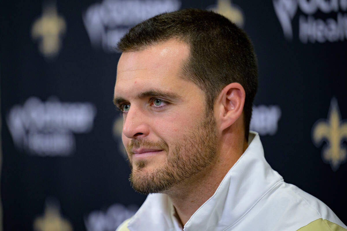 Derek Carr listens during an NFL football news conference where he was introduced as the new qu ...