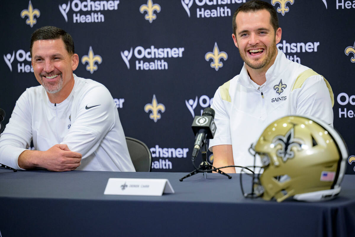 Derek Carr, right, smiles as he is introduced as the new quarterback of the New Orleans Saints ...