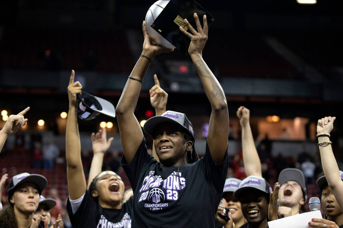 UNLV Lady Rebels center Desi-Rae Young holds up her tournament MVP trophy as her team erupts in ...