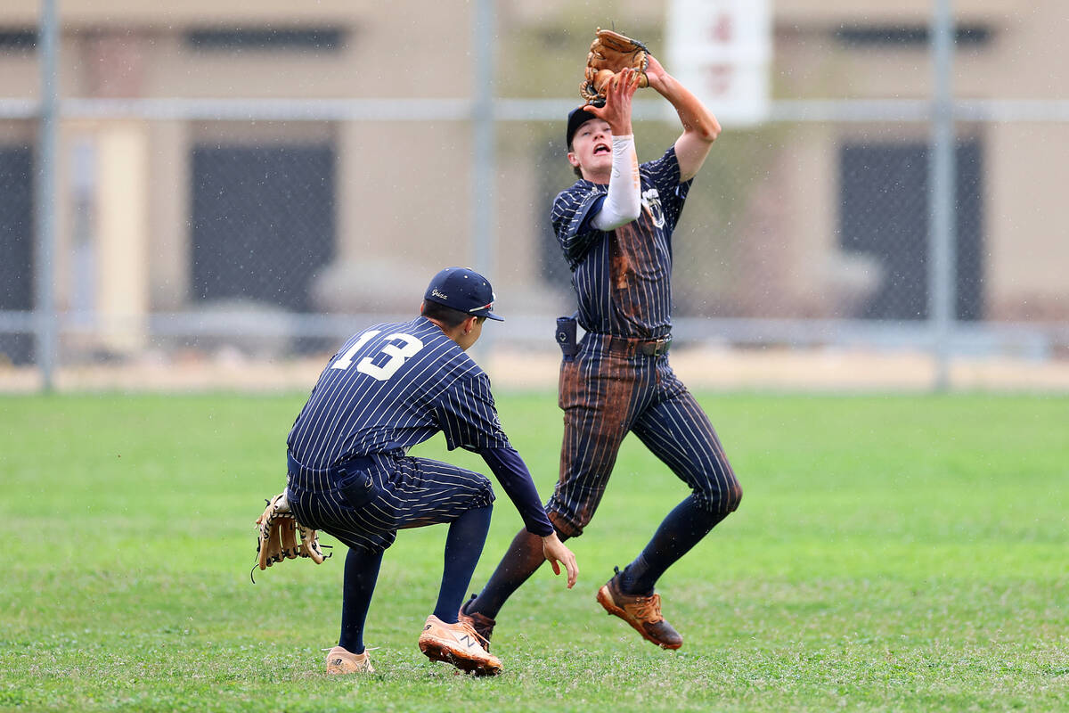 Spring Valley's Grant Kelly (27) makes a catch in the outfield as his teammate Eddy Zurita (13) ...