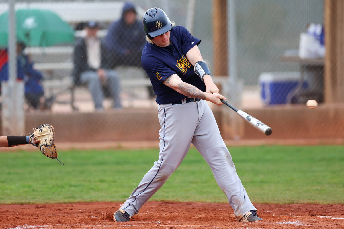 Boulder City's Dylan Spencer (13) connects with the ball for a single during a spring break bas ...