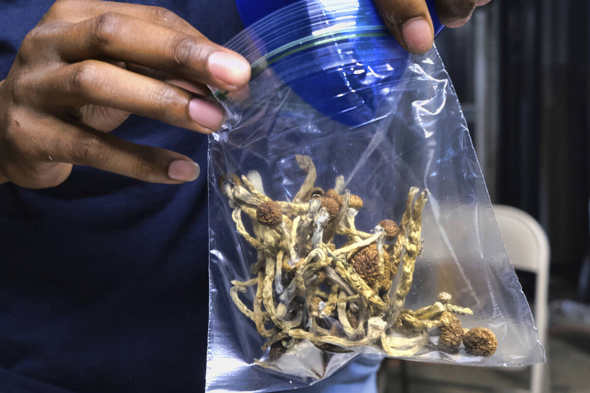 FILE - A vendor bags psilocybin mushrooms at a cannabis marketplace on May 24, 2019 in Los Ange ...