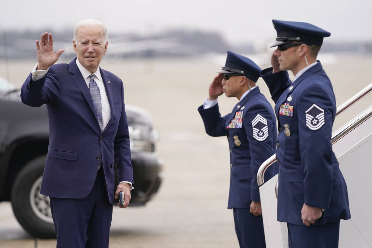 President Joe Biden waves before boarding Air Force One for a trip to San Diego on Monday, Marc ...