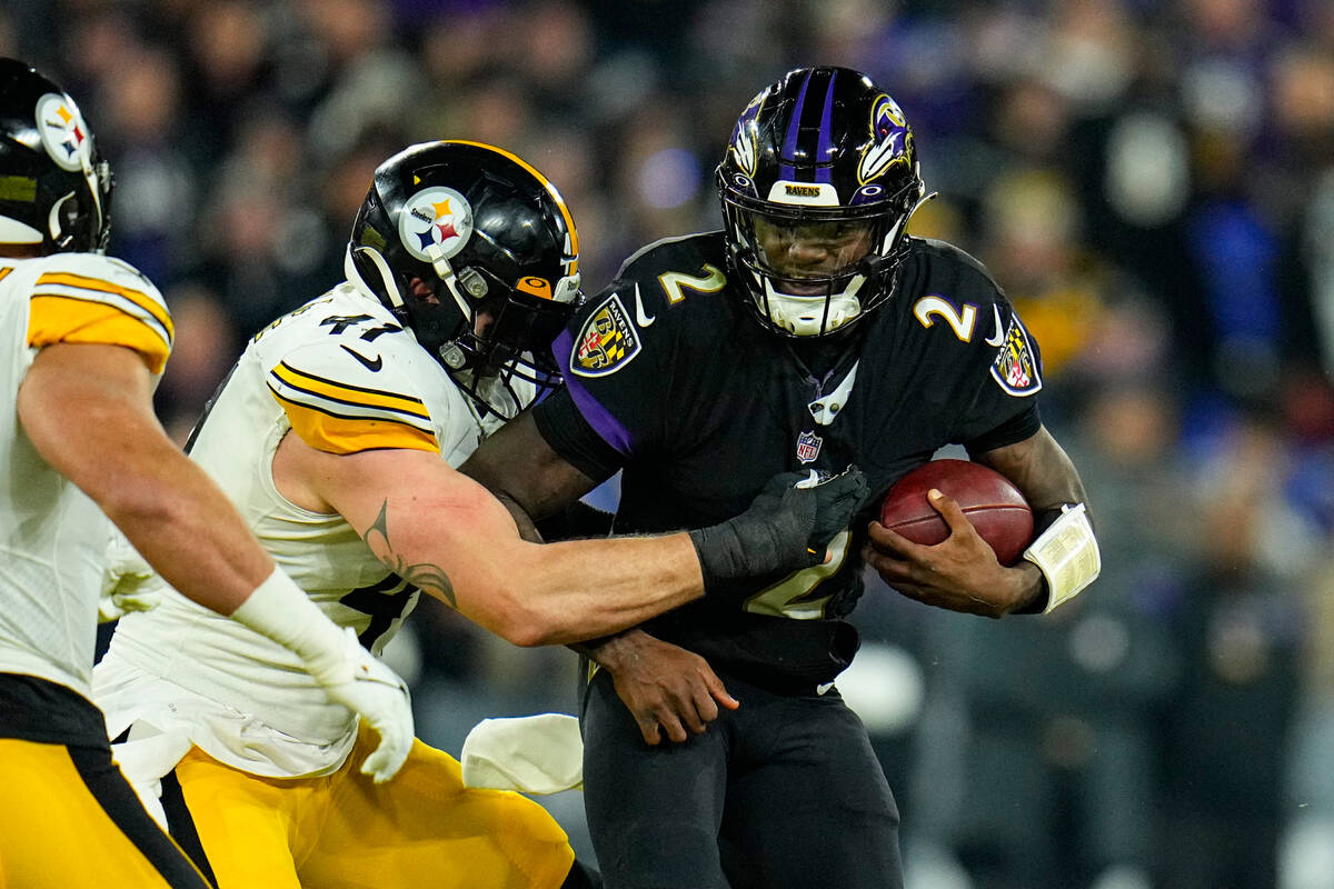 Pittsburgh Steelers linebacker Robert Spillane (41) tackles Baltimore Ravens quarterback Tyler ...