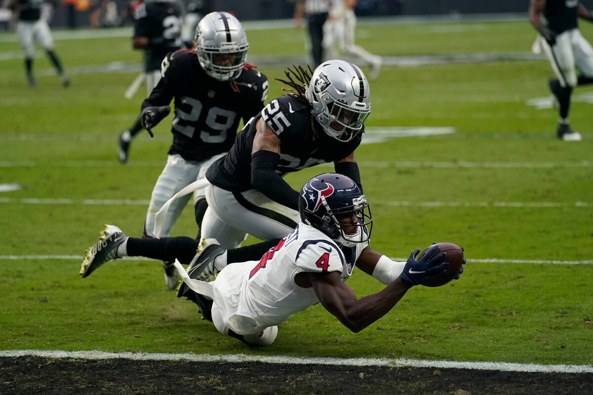 Houston Texans wide receiver Phillip Dorsett bobbles the ball before scoring a touchdown as Las ...