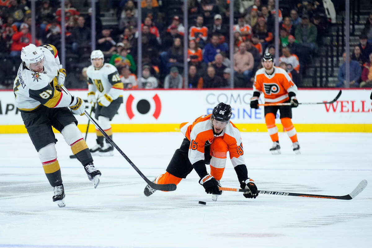 Vegas Golden Knights' Jonathan Marchessault, left, passes the puck against Philadelphia Flyers' ...