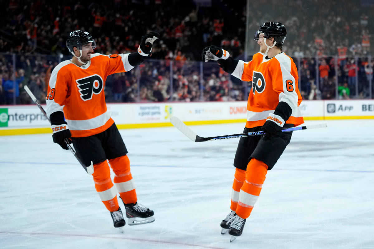 Philadelphia Flyers' Travis Sanheim, right, and Noah Cates celebrate after a goal by Sanheim du ...