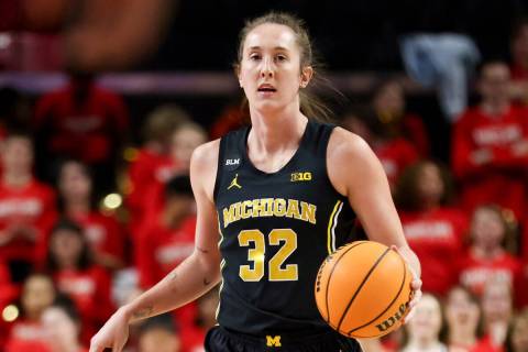 Michigan guard Leigha Brown dribbles the ball during an NCAA college basketball game against Ma ...