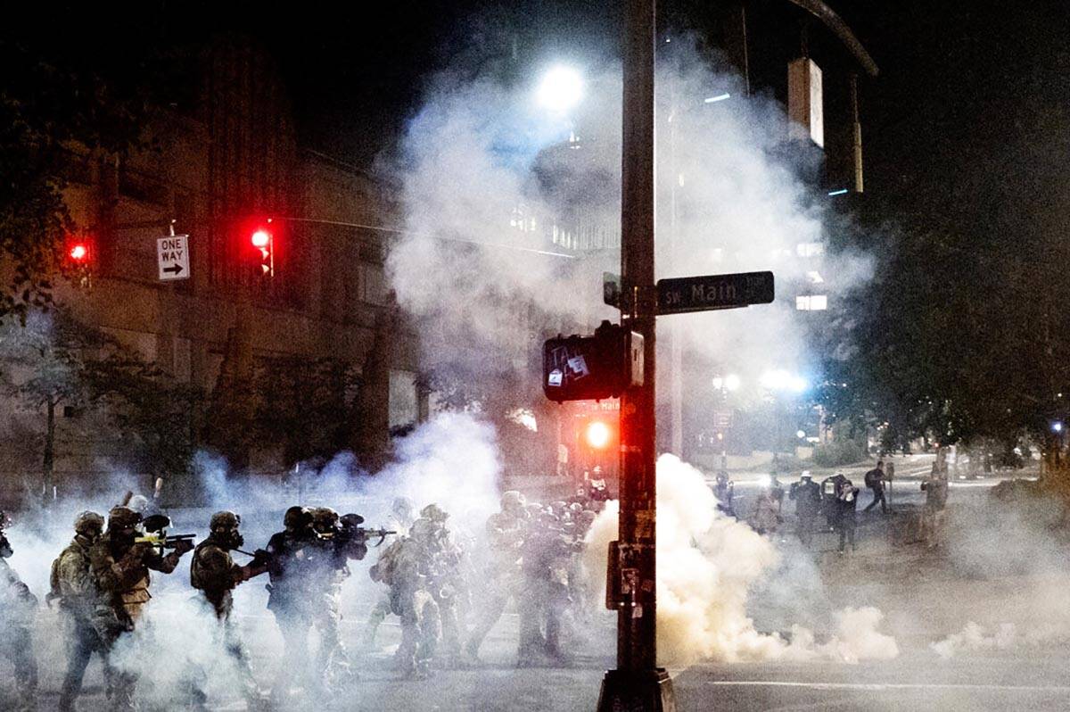 Federal agents use crowd control munitions to disperse Black Lives Matter protesters near the M ...