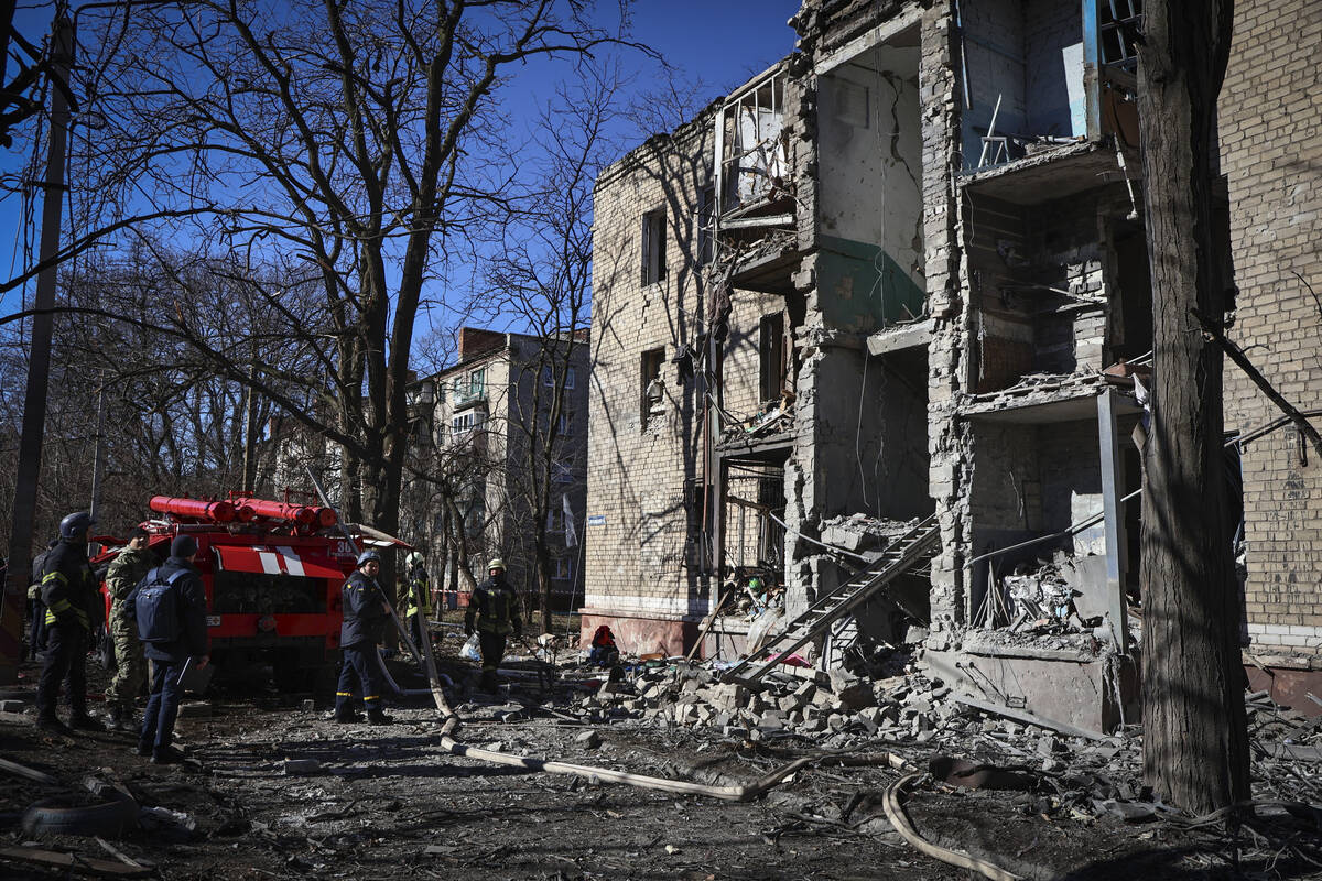Ukrainian Emergency Service rescuers work on a building damaged by shelling in Kramatorsk, Done ...