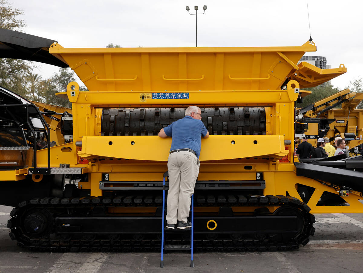 Mark Salmon of Highway Equipment Company in Butler, Pa. checks out a High torque shredder, used ...