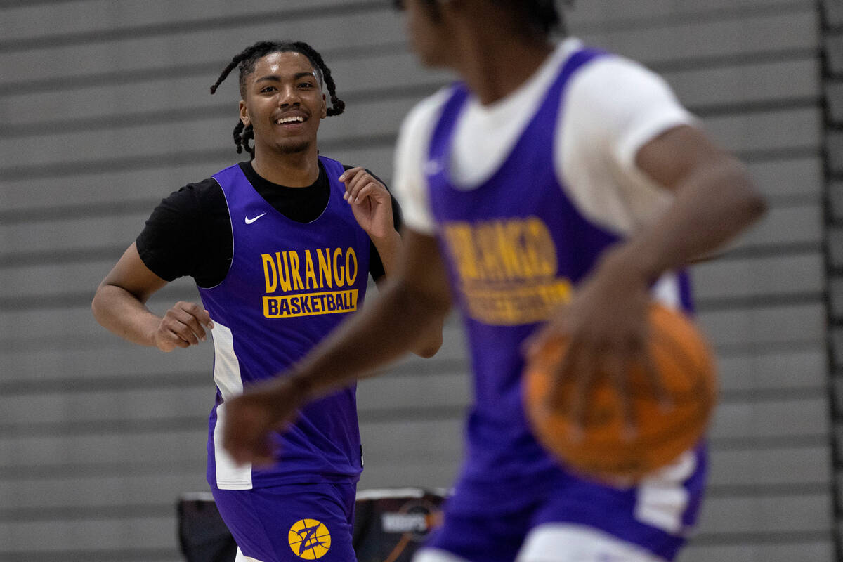 Durango’s Taj Degourville, left, laughs with teammate Tylen Riley, right, during a boys ...